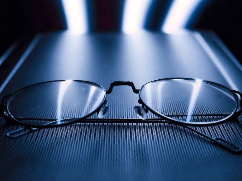Eyeglasses with light reflecting off the lenses